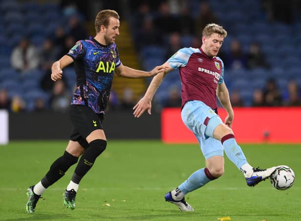 Nathan Collins of Burnley battles for possession with Harry Kane of Tottenham Hotspur during the Carabao Cup Round of 16 match between Burnley and Tottenham Hotspur at Turf Moor on October 27, 2021 in Burnley, England.
