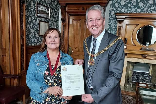 Vivien Storey receives her medal honour from the Mayor of Burnley Coun. Mark Townsend