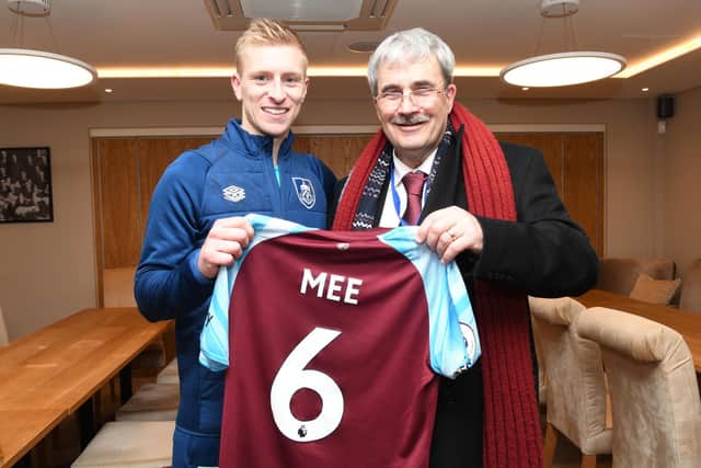 Burnley captain Ben Mee gifts his shirt from the Spurs match to Chris Coxhead. Photo: Burnley Football Club.