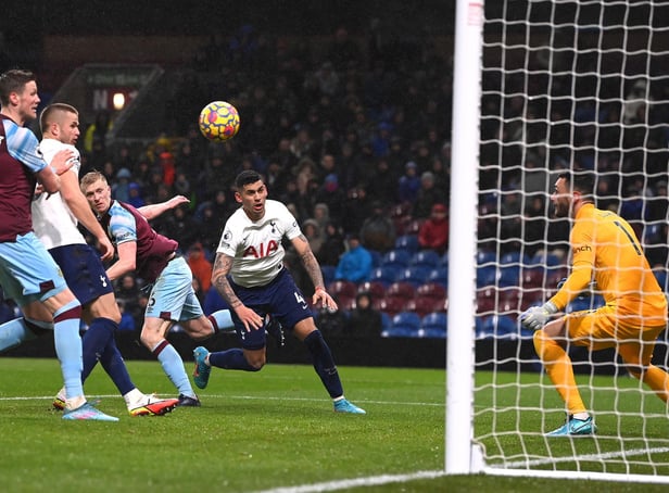 Burnley player Ben Mee beats Tottenham player Cristian Romero to head the winning goal during the Premier League match between Burnley and Tottenham Hotspur at Turf Moor on February 23, 2022 in Burnley, England.