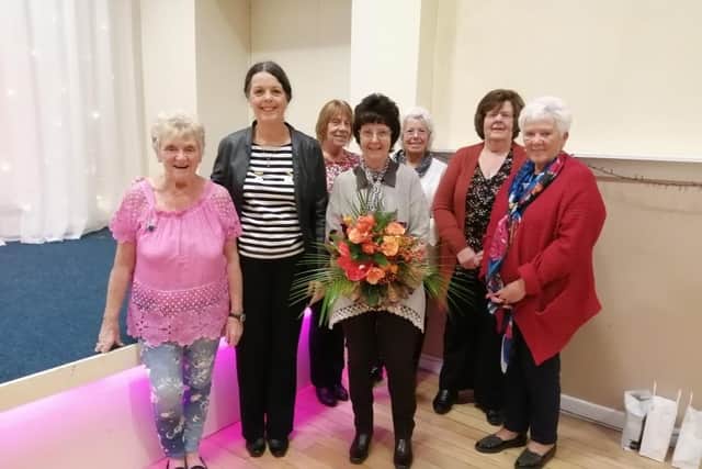 Wendy Graveston (second from left) presents the outgoing chairman Carole Mellows with a bouquet watched by fellow committee members of Whalley and District Flower Club.