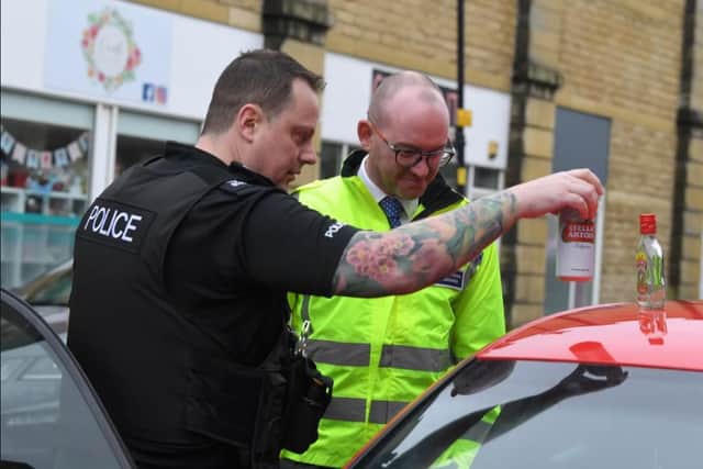 First of the day - Police and Crime Commissioner Andrew Snowden is shown alcohol found in the car of a suspected drink driver.