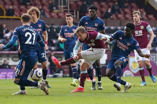 Matej Vydra of Burnley shoots whilst under pressure from Bukayo Saka of Arsenal during the Premier League match between Burnley and Arsenal at Turf Moor on March 06, 2021 in Burnley, England.