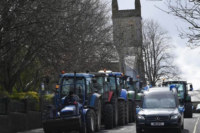 Tractors big and small join the funeral procession