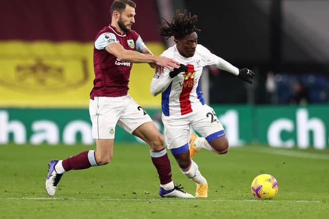 Eberechi Eze of Crystal Palace is challenged by Erik Pieters of Burnley during the Premier League match between Burnley and Crystal Palace at Turf Moor on November 23, 2020 in Burnley, England.