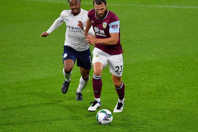 Erik Pieters of Burnley is challenged by Raheem Sterling of Manchester City during the Carabao Cup fourth round match between Burnley and Manchester City at Turf Moor on September 30, 2020 in Burnley, England.