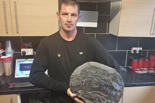 Damion Whitton with the rare fish fossil he discovered in Burnley