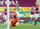 Burnley's English goalkeeper Bailey Peacock-Farrell (down) stops the ball next to Newcastle United's English striker Dwight Gayle (up) during the English Premier League football match at Turf Moor in Burnley, north west England on April 11, 2021.