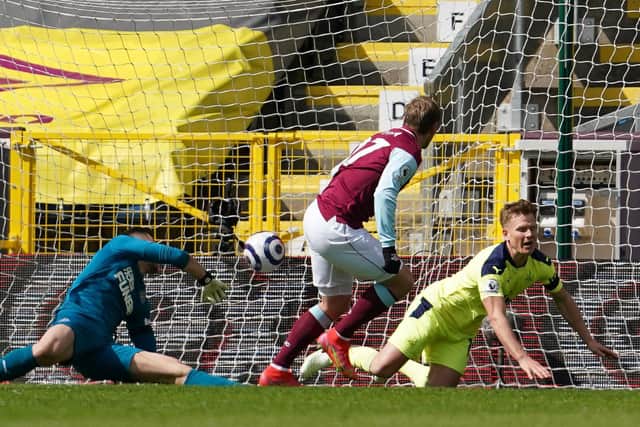 Burnley's Czech striker Matej Vydra (2R) shoots and scores the first goal past Newcastle United's Slovakian goalkeeper Martin Dubravka (L) during the English Premier League football match at Turf Moor in Burnley, north west England on April 11, 2021.