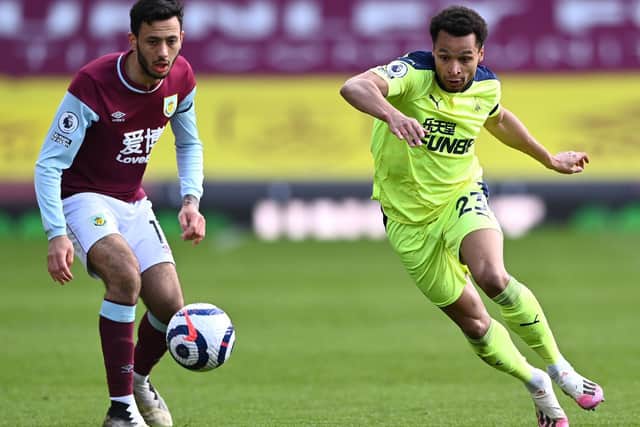 Jacob Murphy of Newcastle beats Dwight McNeil of Burnley to the loose ball during the Premier League match between Burnley and Newcastle United at Turf Moor on April 11, 2021 in Burnley, England.