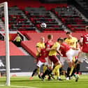 James Tarkowski of Burnley scores his team's first goal during the Premier League match between Manchester United and Burnley at Old Trafford on April 18, 2021 in Manchester, England.