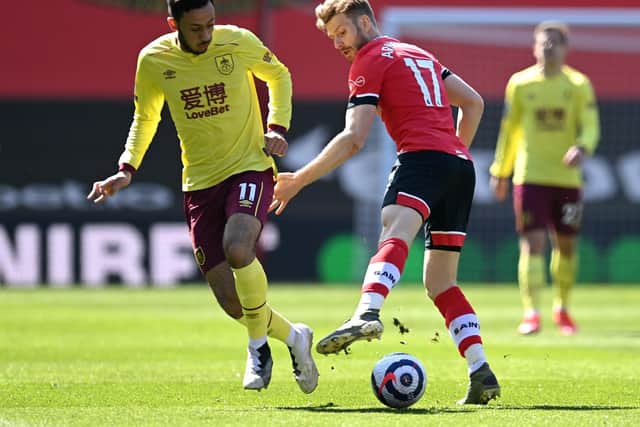 Dwight McNeil of Burnley battles for possession with Stuart Armstrong of Southampton during the Premier League match between Southampton and Burnley at St Mary's Stadium on April 04, 2021 in Southampton, England.