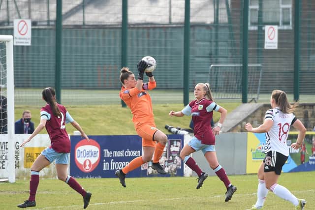 Burnley FC Women's goalkeeper Lauren Bracewell comes out to claim a cross.