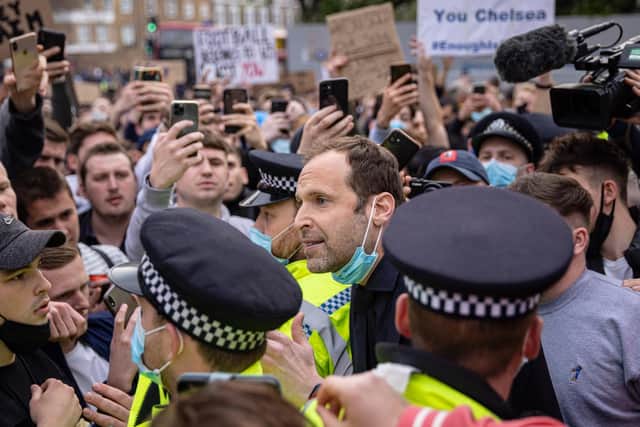 Chelsea Technical Advisor Petr Čech (centre) speaks to fans of Chelsea Football Club protesting outside the team's Stamford Bridge ground on April 20, 2021 in London, England.