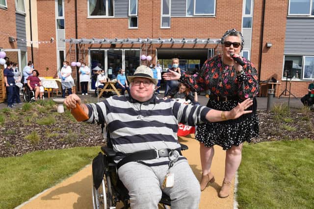 Singer Dani Wallace entertained residents and staff at the tea party with her music making - which was also much appreciated by her dad, former Preston Councillor  Danny Gallagher who lives at the Sue Ryder Neurological Care Centre  Photo: Neil Cross