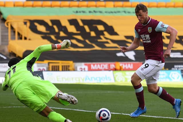 Burnley's New Zealand striker Chris Wood (C) scores his team's second goal past Wolverhampton Wanderers' Portuguese goalkeeper Rui Patricio (L) during the English Premier League football match at the Molineux stadium in Wolverhampton.