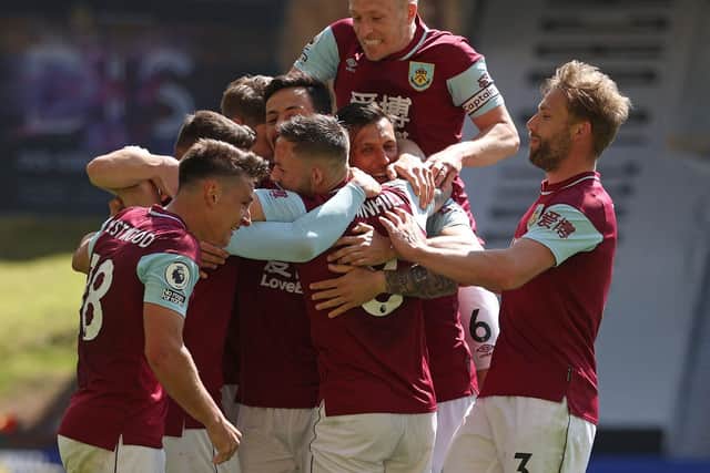 Burnley's English midfielder Ashley Westwood (R) is mobbed by teammates after scoring his team's fourth goal during the English Premier League football match between Wolverhampton Wanderers and Burnley at the Molineux stadium in Wolverhampton.