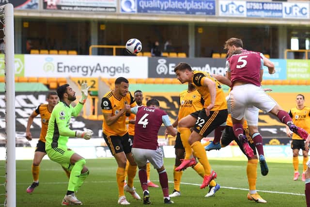 Chris Wood of Burnley scores their side's third goal past Rui Patricio of Wolverhampton Wanderers during the Premier League match between Wolverhampton Wanderers and Burnley at Molineux on April 25, 2021 in Wolverhampton, England.