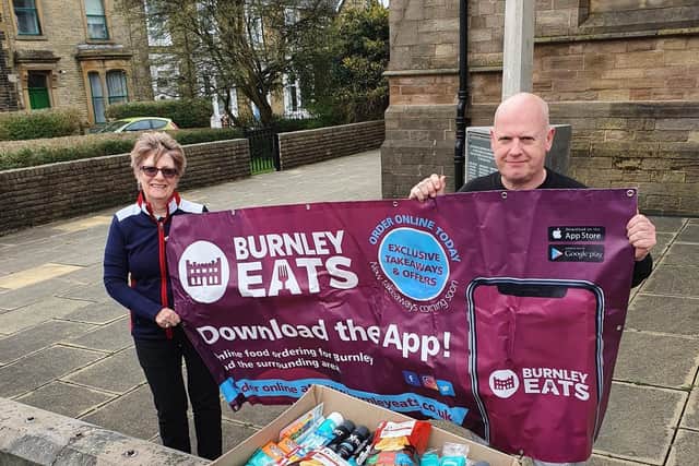 Burnley Eats sales director Karl Greenwood hands over the box of mens' toiletries to Pat Greenwood at St Matthew's Church.