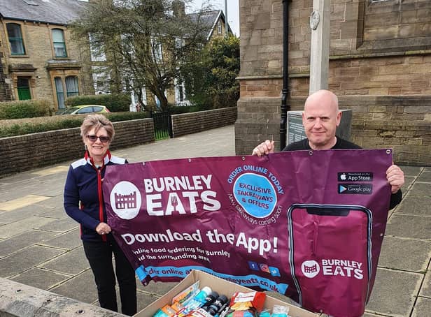Burnley Eats sales director Karl Greenwood hands over the box of mens' toiletries to Pat Greenwood at St Matthew's Church.