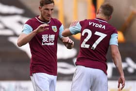 Burnley striker Chris Wood (L) celebrates scoring his team's first goal with Matej Vydra (R) during the English Premier League match between Wolverhampton Wanderers and Burnley at the Molineux stadium in Wolverhampton, central England on April 25, 2021.