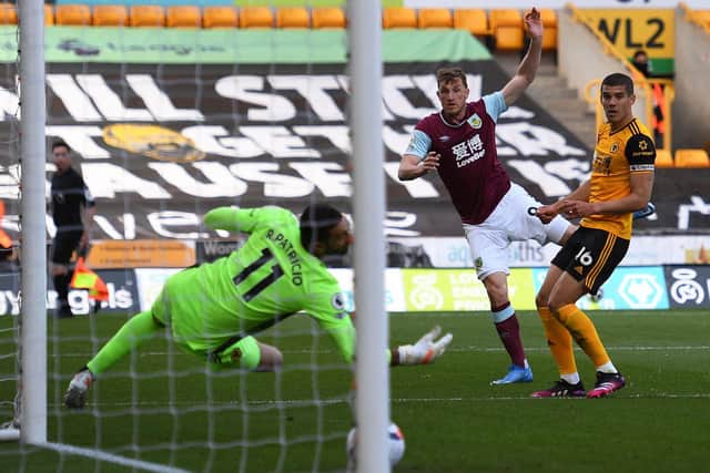Burnley's New Zealand striker Chris Wood (C) scores his team's first goal during the English Premier League football match between Wolverhampton Wanderers and Burnley at the Molineux stadium in Wolverhampton, central England on April 25, 2021.
