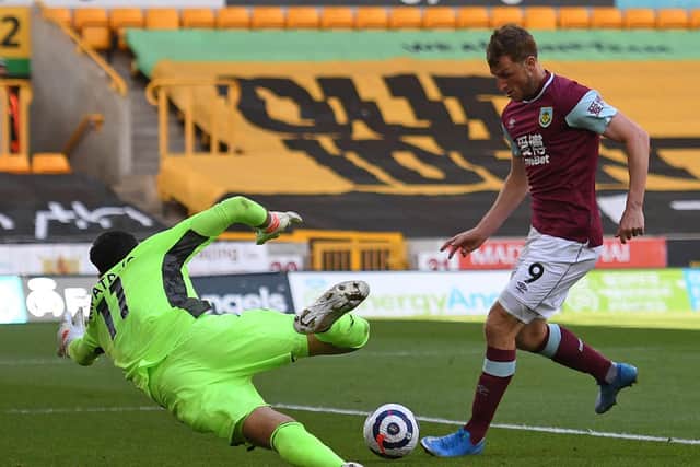 Burnley's New Zealand striker Chris Wood (R) scores his team's second goal past Wolverhampton Wanderers' Portuguese goalkeeper Rui Patricio during the English Premier League football match at the Molineux stadium in Wolverhampton, central England on April 25, 2021.