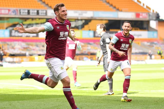 Chris Wood of Burnley celebrates after scoring their side's third goal and his hat trick during the Premier League match between Wolverhampton Wanderers and Burnley at Molineux on April 25, 2021 in Wolverhampton, England.