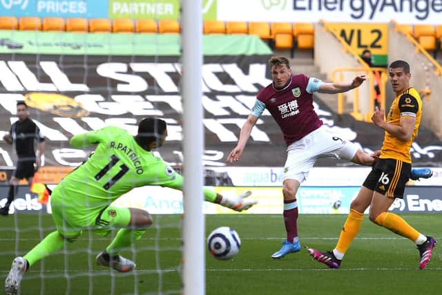 Chris Wood of Burnley scores their team's first goal past Rui Patricio of Wolverhampton Wanderers during the Premier League match between Wolverhampton Wanderers and Burnley at Molineux on April 25, 2021 in Wolverhampton, England.
