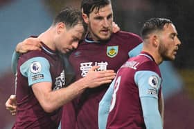 Burnley's English striker Ashley Barnes (L) celebrates with Burnley's New Zealand striker Chris Wood (C) after scoring first goal during the English Premier League football match between Burnley and Wolverhampton Wanderers at Turf Moor on December 21, 2020.