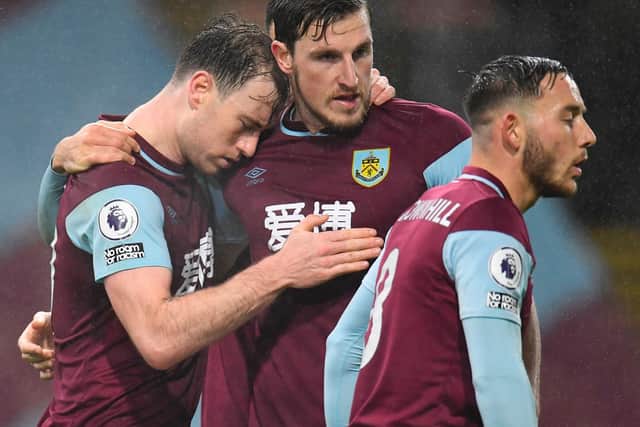 Burnley's English striker Ashley Barnes (L) celebrates with Burnley's New Zealand striker Chris Wood (C) after scoring first goal during the English Premier League football match between Burnley and Wolverhampton Wanderers at Turf Moor on December 21, 2020.