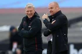 West Ham United's Scottish manager David Moyes (L) talks with Burnley's English manager Sean Dyche ahead of the English Premier League football match between West Ham United and Burnley at The London Stadium, in east London on January 16, 2021.