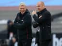 West Ham United's Scottish manager David Moyes (L) talks with Burnley's English manager Sean Dyche ahead of the English Premier League football match between West Ham United and Burnley at The London Stadium, in east London on January 16, 2021.