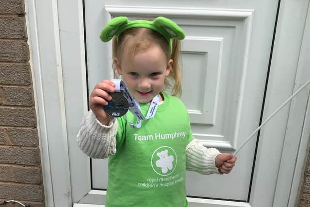 Quinn shows off the medal she received for completing the 30 Miles My Way challenge to raise £4,500