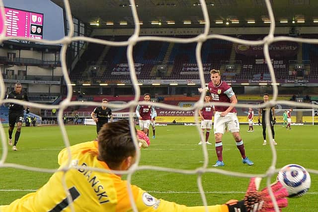 Burnley's New Zealand striker Chris Wood scores a penalty past West Ham United's Polish goalkeeper Lukasz Fabianski during the English Premier League football match between Burnley and West Ham United at Turf Moor in Burnley, north west England, on May 3, 2021.