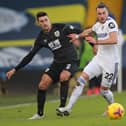 Jack Harrison of Leeds United battles for possession with Matthew Lowton of Burnley during the Premier League match between Leeds United and Burnley at Elland Road on December 27, 2020 in Leeds, England.