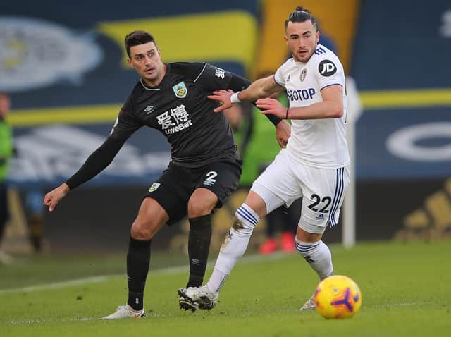 Jack Harrison of Leeds United battles for possession with Matthew Lowton of Burnley during the Premier League match between Leeds United and Burnley at Elland Road on December 27, 2020 in Leeds, England.
