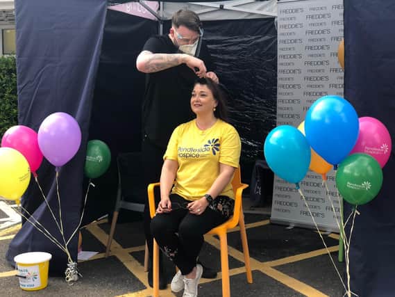 Lisa Pearson during the her head shave by Nick Wright at Pendleside Hospice
