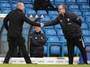 Burnley's English manager Sean Dyche (L) and Leeds United's Argentinian head coach Marcelo Bielsa (R) shake hands ahead of the English Premier League football match between Leeds United and Burnley at Elland Road in Leeds, northern England on December 27, 2020.