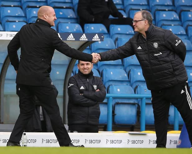 Burnley's English manager Sean Dyche (L) and Leeds United's Argentinian head coach Marcelo Bielsa (R) shake hands ahead of the English Premier League football match between Leeds United and Burnley at Elland Road in Leeds, northern England on December 27, 2020.