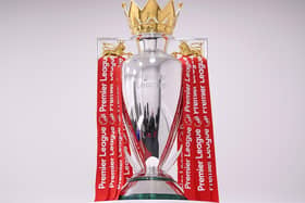 The Premier League Trophy is dressed in Liverpool Red Ribbons ready for the presentation ceremony ahead of the Premier League match between Liverpool FC and Chelsea FC at Anfield on July 22, 2020 in Liverpool, England.