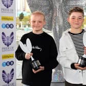 Inspirational best friends Hughie Higginson and Freddie Xavi with their Pride of Manchester trophies