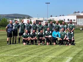 The 'Harry's Barmy Army' team take to the pitch with Mark (centre holding the football)