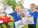 Emily and Solomon from St James' Primary School with their winning designs