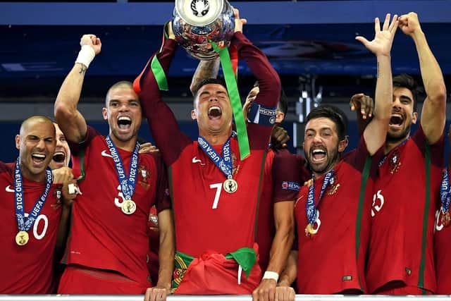 Cristiano Ronaldo of Portugal (c) lifts the Henri Delaunay trophy after his side win 1-0 against France during the UEFA EURO 2016 Final match between Portugal and France at Stade de France on July 10, 2016 in Paris, France.
