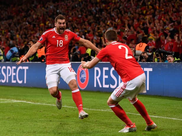 Sam Vokes (L) of Wales celebrates scoring his team's third goal with his team mates Chris Gunter (R) during the UEFA EURO 2016 quarter final match between Wales and Belgium at Stade Pierre-Mauroy on July 1, 2016 in Lille, France.