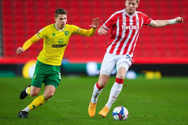 Nathan Collins of Stoke City and Jacob Sorensen of Norwich City during the Sky Bet Championship match between Stoke City and Norwich City at Bet365 Stadium on November 24, 2020 in Stoke on Trent, England.