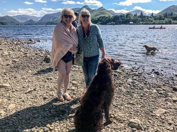 Sue Plunkett (left) after her open swimming experience in Derwentwater with her long time friend Marie and her dog Harley