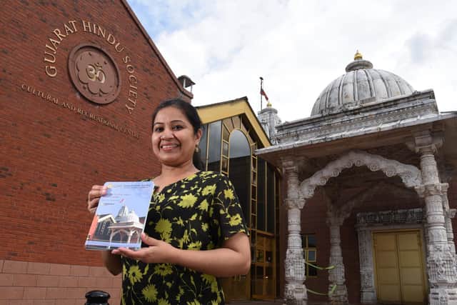 Centre Manager Abhi Kodanda pictured with the new guidebook outside the Gujarat Hindu Society temple    Photo: Neil Cross