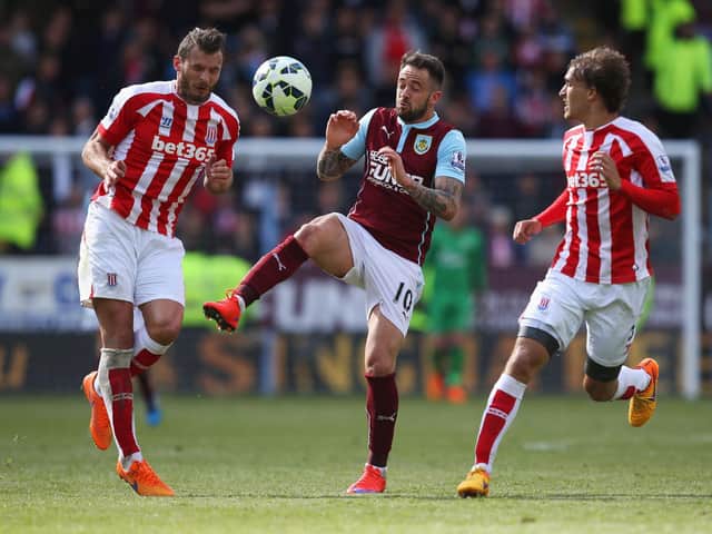 Danny Ings (C) of Burnley competes for the ball against Erik Pieters (L) and Marc Muniesa (R) of Stoke City during the Barclays Premier League match between Burnley and Stoke City at Turf Moor on May 16, 2015 in Burnley, England.